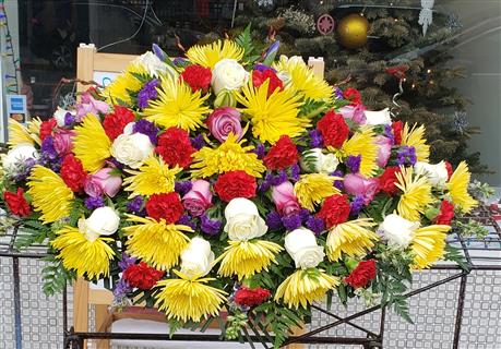 YELLOWS AND PURPLES CASKET SPRAY